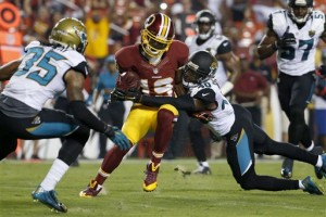 Washington Redskins wide receiver Rashad Ross (19) breaks a tackle from Jacksonville Jaguars cornerback Rashaad Reynolds (40) during the first half of an NFL preseason football game in Landover, Md., Thursday, Sept. 3, 2015. (AP Photo/Alex Brandon)