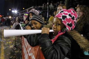 In this Jan. 1, 2013 file photo, children watch the 113th annual Mummers Parade in Philadelphia. For the 2016 parade, organizers of the colorful New Year's celebration are creating a division for groups of minority performers, in response to critics who say the parade is perceived as exclusionary and that it's mostly white. (AP Photo/Joseph Kaczmarek, File)