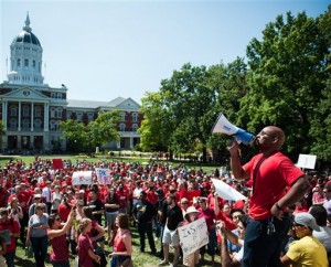 In this Aug. 26, 2015 photo, Jonathan Butler uses a megaphone to encourage others to chant during a "day of action" demonstration celebrating graduate students and draw attention to their demands near the columns on the University of Missouri campus in Columbia, Mo. Butler began his hunger strike on Nov. 2 to call attention to racial problems at the state's flagship university. (Daniel Brenner/Columbia Daily Tribune via AP) MANDATORY CREDIT