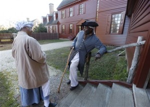 In this photo taken on Tuesday, Dec. 15, 2015, historical interpreters Robert Watson Jr., talks with a fellow interpreter, Janice Canaday, left, at the Randolph house in the restored area of Colonial Williamsburg in Williamsburg, Va. Despite a growing and continuing emphasis on African-American history, Colonial Williamsburg has struggled to attract more black visitors to the historic village where interpreters stroll the streets attired in bonnets and tricorn hats. Its a hard sell when human enslavement is a part of the story youre trying to tell. (AP Photo/Steve Helber)