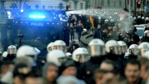 Police drive back right-wing demonstrators using a water cannon during protests in Cologne, Germany, Saturday Jan. 9, 2016. Womens rights activists, far-right demonstrators and left-wing counter-protesters all took to the streets of Cologne on Saturday in the aftermath of a string of New Years Eve sexual assaults and robberies in Cologne blamed largely on foreigners.. (Monika Skolimowska/dpa via AP)