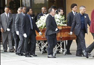 Pallbearers carry the casket of Natalie Cole after funeral services at West Angeles Church of God in Christ in the Crenshaw district of Los Angeles, Monday, Jan. 11, 2016. The Rev. Jesse Jackson follows at far left. The R&B singer Cole died on New Year's eve at age 65. (AP Photo/Nick Ut)