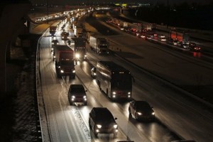 Traffic is bumper to bumper and mostly at a stand-still on the outer loop of the I-495 Capital Beltway after snow fell Wednesday, Jan. 20, 2016, in National Harbor, Md. As Washington prepares for this weekend's snowstorm, now forecast to reach blizzard conditions, a small clipper system pushed through the region Wednesday night causing massive delays and issues on the roads. (AP Photo/Alex Brandon)