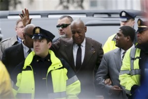 Actor and comedian Bill Cosby, center, waves to shouting fans as he arrives for a court appearance Wednesday, Feb. 3, 2016, in Norristown, Pa. Cosby was arrested and charged with drugging and sexually assaulting a woman at his home in January 2004. A judge will decide whether to dismiss a sexual assault case against the comedian over an unwritten promise of immunity that a former prosecutor says he gave Cosby's now-deceased lawyer. (AP Photo/Mel Evans)