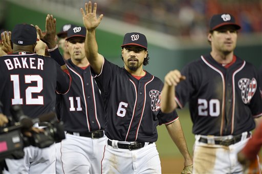Washington Nationals' Anthony Rendon (6), manager Dusty Baker (12), Daniel Murphy (20) and Ryan Zimmerman (11) celebrate win over the Minnesota Twins after an interleague baseball game, Friday, April 22, 2016, in Washington. The Nationals won 8-4. (AP Photo/Nick Wass)